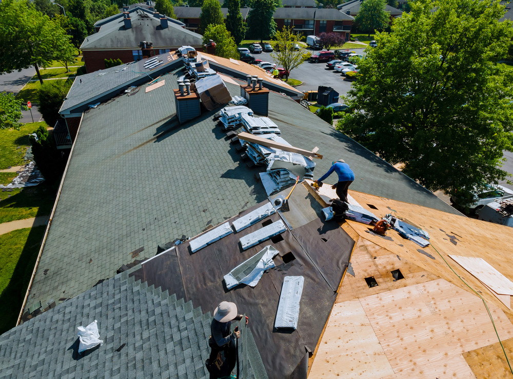 Construction worker on renovation roof the house installed new shingles